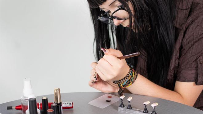 Young person painting press on nails