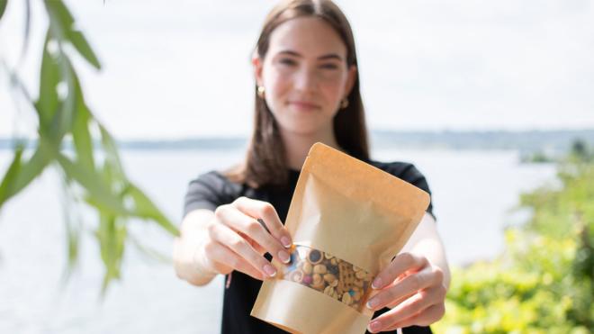 Young person holding a bag of trail mix