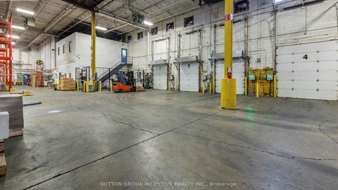 Spacious warehouse interior with loading docks.