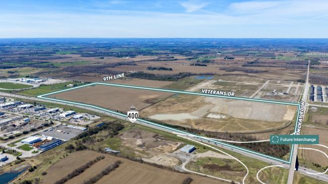 Aerial view of a vast, open rural land outlined by Hwy 400, 9th Line, Veterans Drive and McKay Road West, and showing a future interchange from McKay onto the highway.