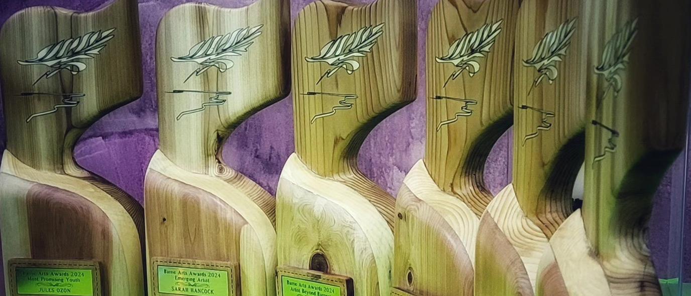 Statuettes carved from wood with an intricate feather design