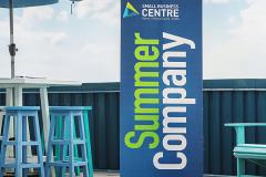 Branded Summer Company banner on patio 