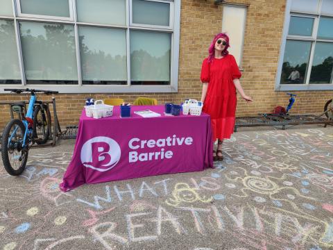 codrington fun fair - Kyra standing at Creative Barrie event table