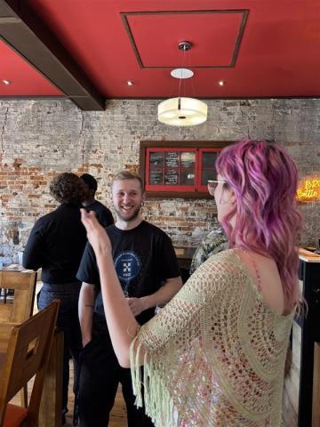 Music sector meet-up candid photo - Kyra speaking to attendee