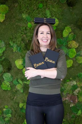 Brandy Mullen posing with Believe Journals in arms